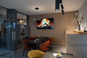 a dining room with a table and a tv on the wall at Villa Silva - Oberhof in Oberhof