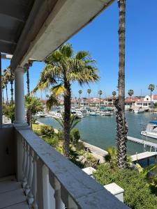 a balcony with a view of a marina with boats at Russells on the Port in Velddrif