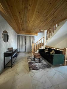 a living room with a couch and a piano at Noon Villa in Kanethi