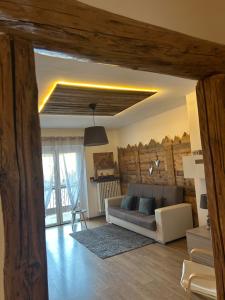 a living room with a couch and a table at Appartamento "Roby" in centro Cavalese in Cavalese