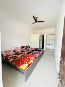 a bed in a room with a ceiling fan at Shivraj guest house in Ābu Road