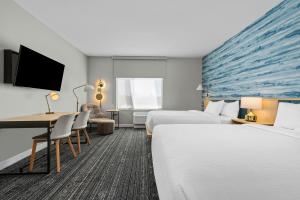 a hotel room with two beds and a desk at TownePlace Suites by Marriott Pell City in Pell City