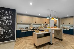 a large kitchen with a blackboard in the middle at TownePlace Suites by Marriott Pell City in Pell City