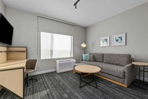 a living room with a couch and a table at TownePlace Suites by Marriott Pell City in Pell City