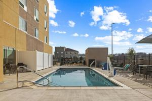 a swimming pool in the courtyard of a building at TownePlace Suites by Marriott Pell City in Pell City