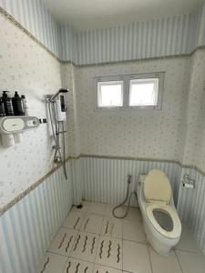 a bathroom with a toilet and a sink at Dans den in Pai +6 photos