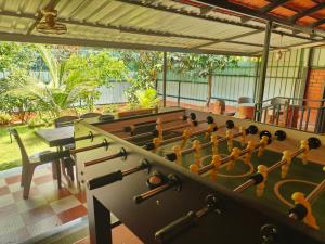 a room with a large billiard table in the middle at UDUPI HOMESTAY - Cottage House - Dendoorkatte, Udupi in Udupi