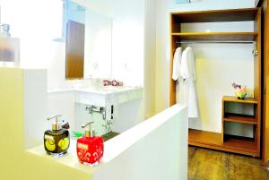 a bathroom with a sink and a red candle on a counter at Moosiyard Hometel Khaoyai in Mu Si