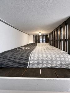 an empty room with a bed on a wooden floor at Loft appartement centrum Dordrecht nieuw 2026 in Dordrecht