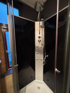 a shower with a glass door in a bathroom at Loft appartement centrum Dordrecht nieuw 2026 in Dordrecht +11 photos