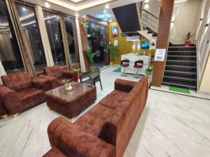 a living room with couches and a table in a building at prabh aasra in Ayodhya