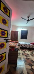 a room with two beds and a ceiling fan at BlaBla House Rishikesh in Rishīkesh