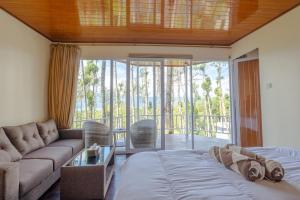 a living room with a bed and a couch at La Pino Mount Batur and Hot Spring in Bangli
