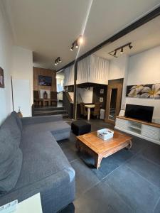 a living room with a couch and a table at Loft appartement centrum Dordrecht nieuw 2026 in Dordrecht