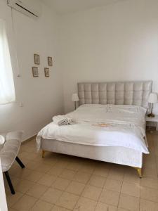 a bedroom with a large bed with a white bedspread at Cringe Boutique APT in Netanya