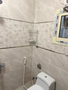 a bathroom with a white toilet and a window at Manazil Al Joud -AlSafa منازل الجود - الصفا in Jeddah +42 photos