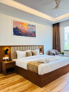 a bedroom with a large bed in a room at Arth Suites Lucknow Gomti Nagar in Lucknow