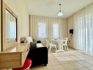 a living room with a couch and a table with chairs at Safak Hotel Dalyan in Dalyan