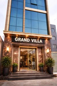 a grand villa building with a sign that reads grand villa at Hotel The Grand Villa by Signature Stayz Near International Airport in New Delhi