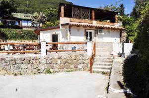 a small building with a stone wall and benches at Small Paradise Palermo in Palermo