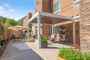 a pergola with chairs and an umbrella on a patio at Fairfield Inn & Suites by Marriott Durango in Durango