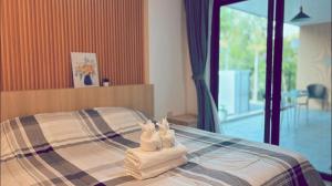 a bedroom with a bed with towels on it at My Home Villa Phangnga in Phangnga +49 photos