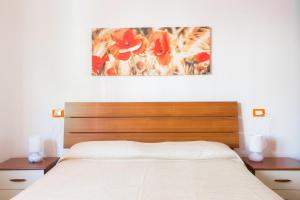 Un pat sau paturi într-o cameră la Appartamenti La Playa