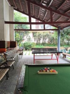 a pool table with a bowl of fruit on it at Snow Lion Riverside Resort in Yangshuo