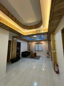 a large room with a living room with a ceiling at Carpenters homestay in Sagada