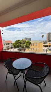 a table and two chairs on a balcony with a view at Two Sixty Nine in Gqeberha