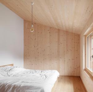 a bedroom with a white bed and a window at Haus Kienzerleweg in Bad Kohlgrub