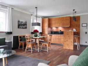 a kitchen and living room with a table and chairs at Kitzbühel Residences in Kitzbühel