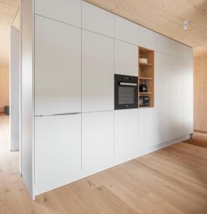 a living room with white walls and a stove at Haus Kienzerleweg in Bad Kohlgrub +8 photos