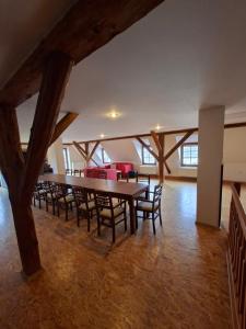a large room with a table and chairs at Hostinec u Janatů s ubytováním in Čestín