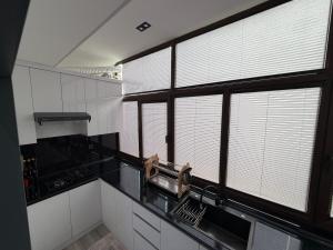 a kitchen with large windows and a counter top at Guest house Пары Резиденты только с ЗАГСом in Samarkand