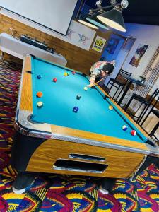 a man playing pool on a pool table at Theodore Motor Hotel in Theodore