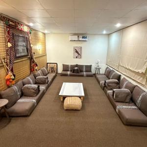 a room with couches and a table in a room at safeer farm in Qūr
