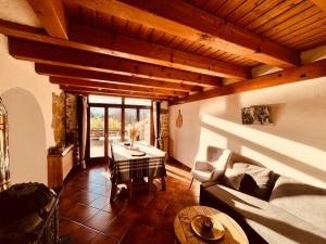 a living room with a couch and a table at Gîte Les sources proche Annecy in Vaulx