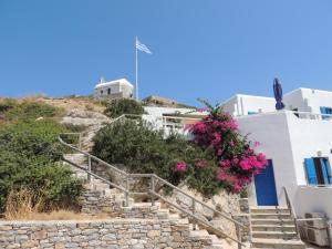 a set of stairs with pink flowers on a building at Armonia by Grispos Villas in Schinoussa