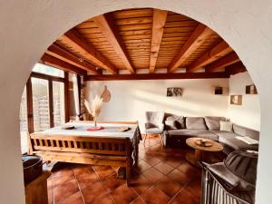 a living room with a couch and a table at Gîte Les sources proche Annecy in Vaulx