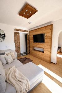 a living room with a couch and a flat screen tv at Gästezimmer Lercher in Sankt Veit im Pongau