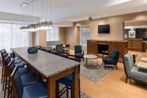 a living room with a table and chairs and a fireplace at Hampton Inn Bartow in Bartow