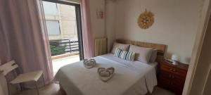 a bedroom with a bed with a heart pillow on it at Sunrise story in Artemida