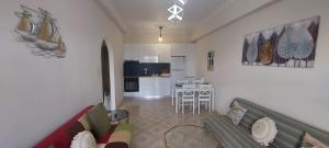 a living room with a couch and a kitchen at Sunrise story in Artemida