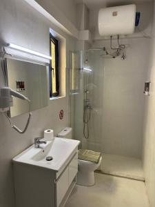 a bathroom with a sink and a shower and a toilet at Sunrise story in Artemida +29 photos