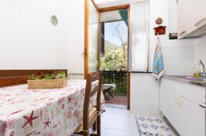 a kitchen with a table and a sink and a window at Apartment Vincenzina in Monterosso al Mare