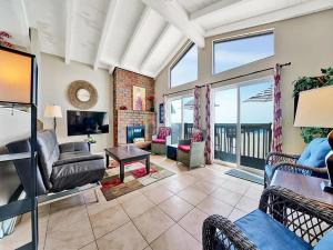a living room filled with furniture and a large window at Oceanfront withIncredible Beach Views home in Newport Beach