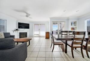a living room with a table and a dining room at Value Beachfront withLarge Patio On The Bike Path apts in Newport Beach
