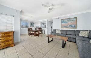 a living room with a couch and a table at Value Beachfront withLarge Patio On The Bike Path apts in Newport Beach
