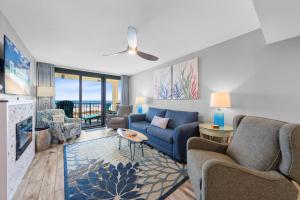 a living room with a blue couch and chairs at Phoenix II 2012 in Orange Beach +35 photos